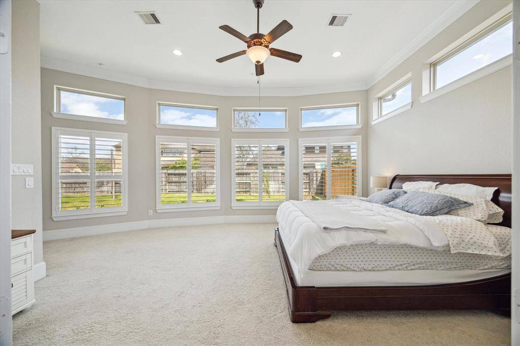 The owner's retreat is very spacious offering a wall of windows that would be the ideal backdrop for a sitting area.