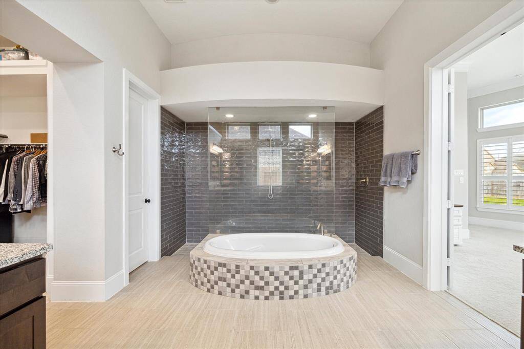 Relax and soak your worries away in this luxurious soaking tub or enjoy a quick rinse in the spacious Greek walk-in shower. Either way, you'll love this private retreat.