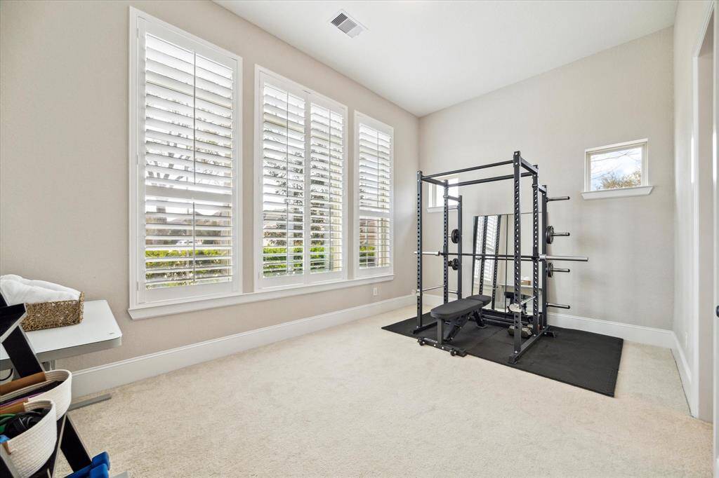 This first floor suite offers luxury accommodations for your guests with plush carpet and neutral paint, wood shuttered windows, a large closet, and ensuite access to a private full bathroom.