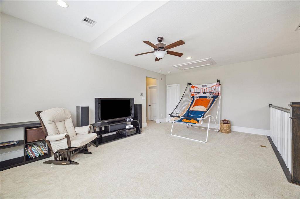 It's all fun and games in this super-sized game room with neutral carpet and paint, recessed lights and a cooling fan, with ample space for your game table and other large furnishings.