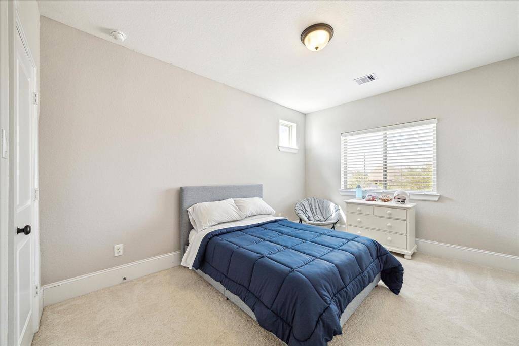 Two spacious guest suites upstairs feature soft neutral carpet and paint, and large closets. Each offers ensuite access to a well-appointed Hollywood bath, making a comfortable retreat for family and guests.