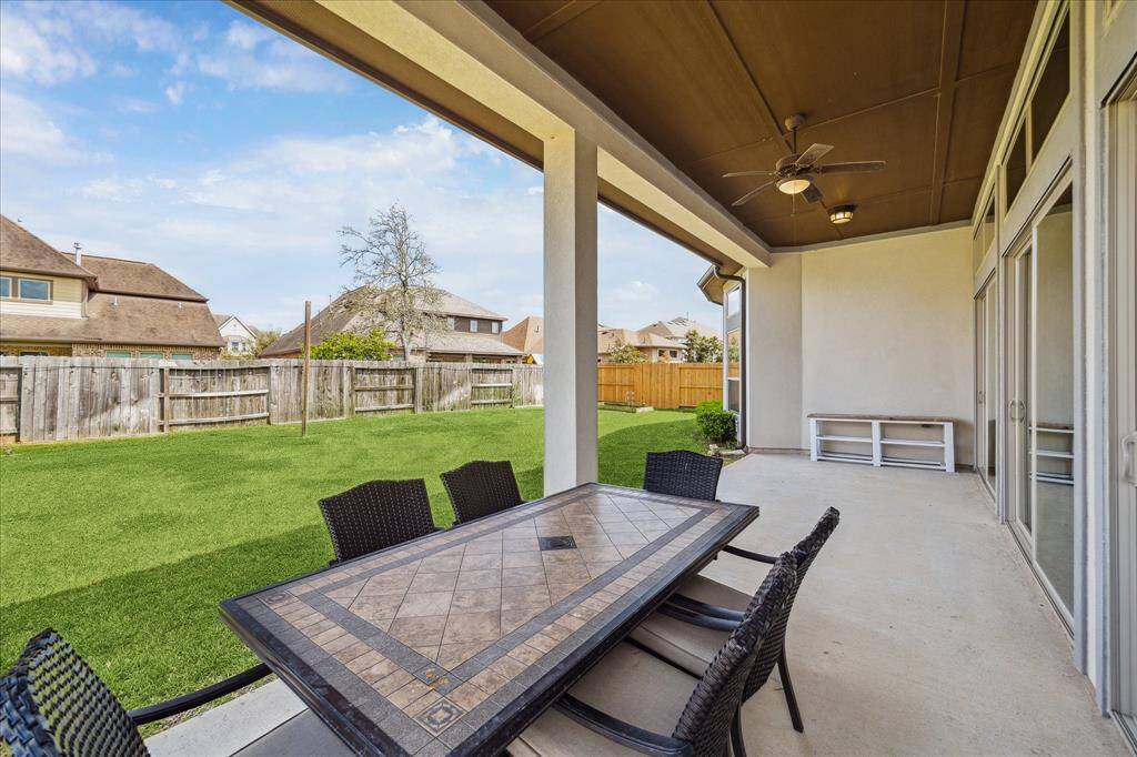 Enjoy summer BBQs and back yard birthday parties with this charming covered patio with a lit ceiling fan and plenty of room for a grill and seating for friends and family.