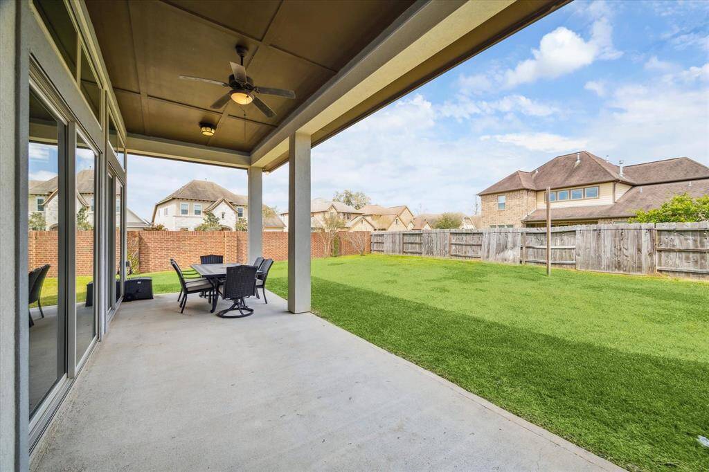 Enjoy the outdoors year-round on this spacious covered patio, perfect for entertaining or relaxing with a morning coffee. With plenty of room for seating and a ceiling fan to keep things comfortable, it’s the ideal spot to take in the fresh air and enjoy the backyard.