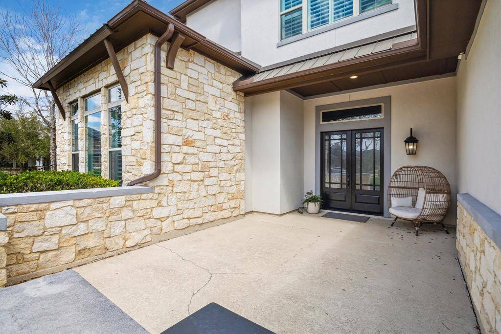 Stylish coach lighting and impressive double doors create a grand first impression.