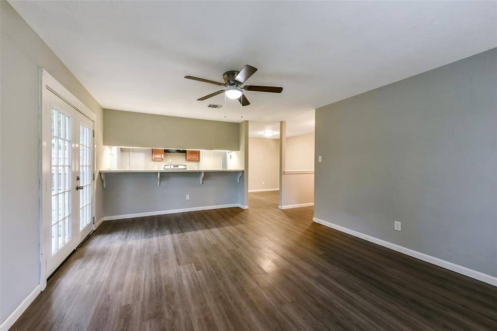 Living room opens to kitchen with bar area