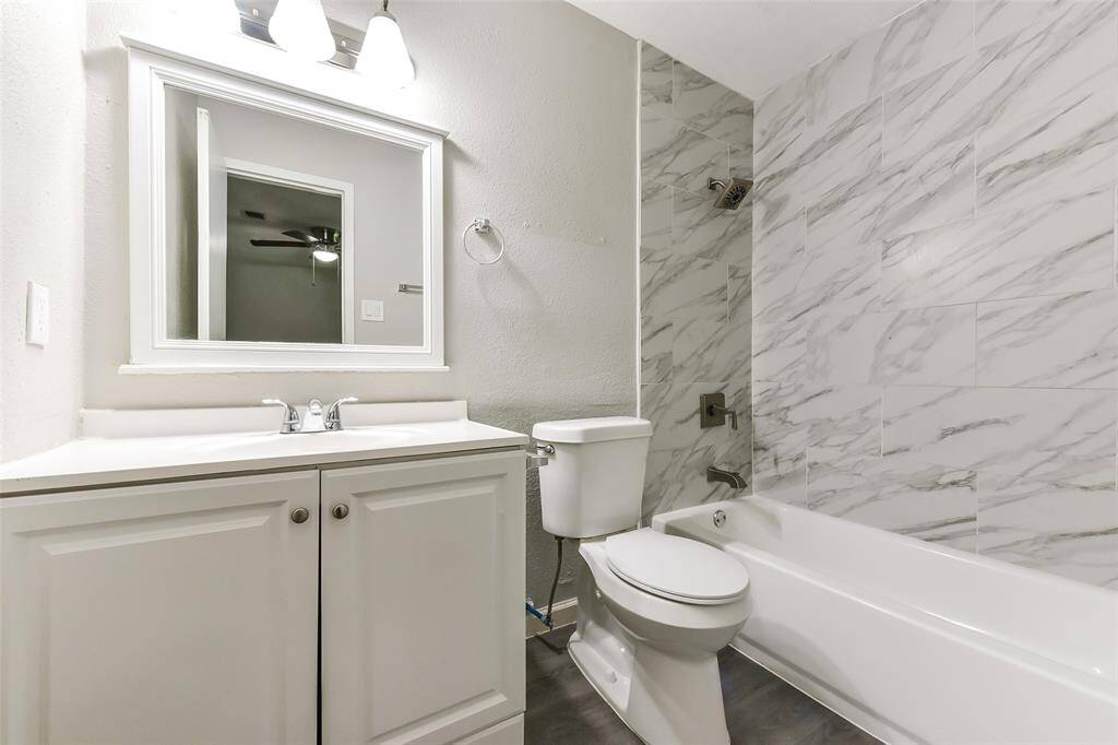 Hall bath has matching finishes and tub/tile shower surround