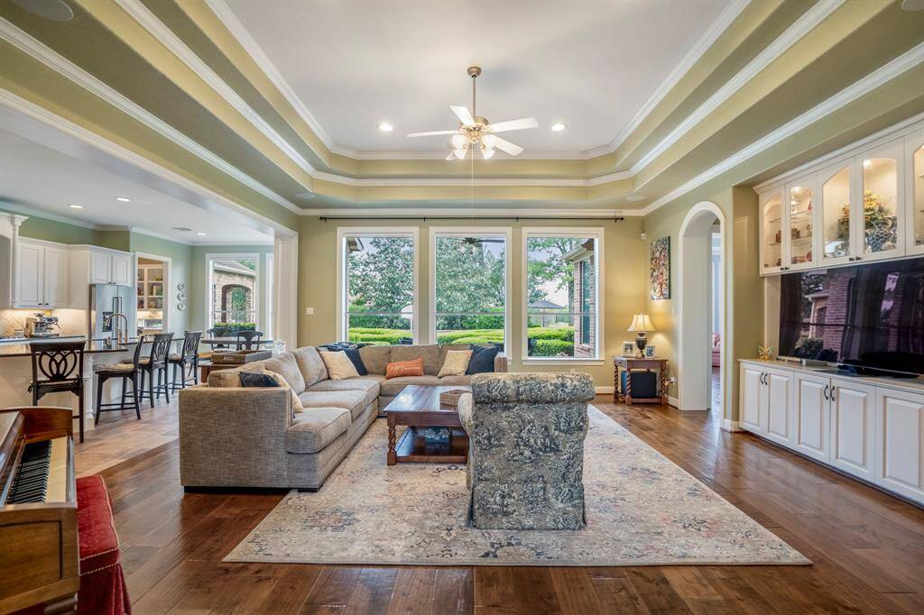 Light that streams into the family room through the large windows has a big impact on the resulting visual two toned massive trey ceiling.
