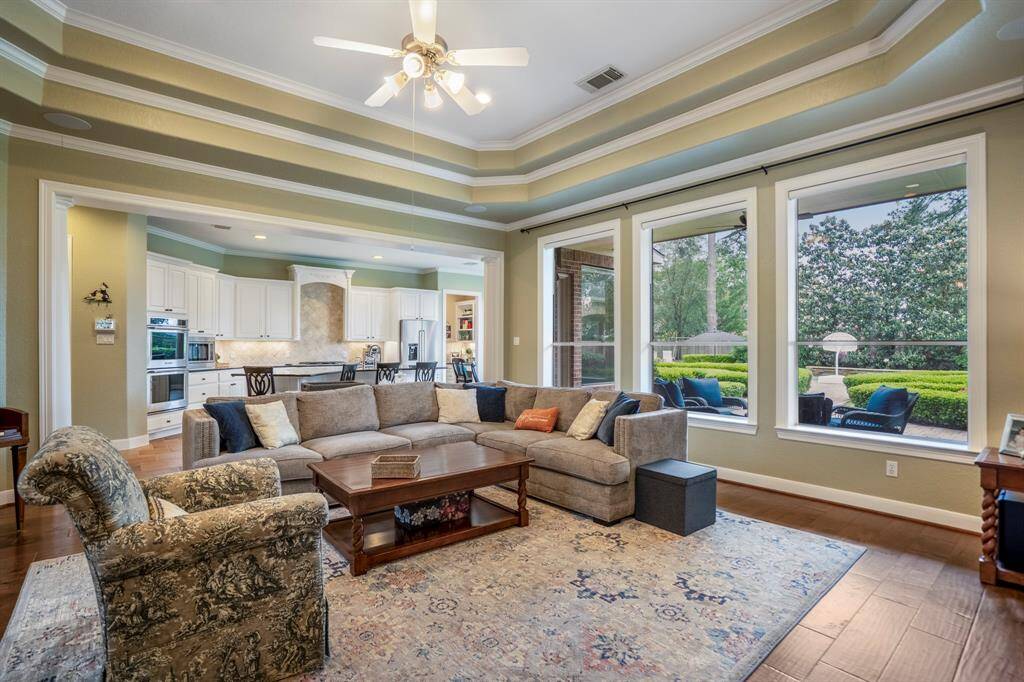 The living room also offers a custom built-in entertainment console or display case for your treasured items.  The open floorplan offers easy access to the kitchen area as well as the outdoor patio.