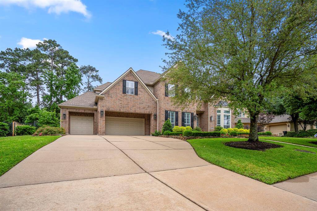 The property features a 4 car garage, with dual wide driveway and maintenance friendly brick elevation, surrounded by majestic trees.