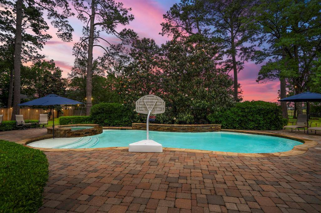 The pool is surrounded by an expansive patio area that could hold several seating areas that all offer the most incredible views of the pond and golf course just beyond.