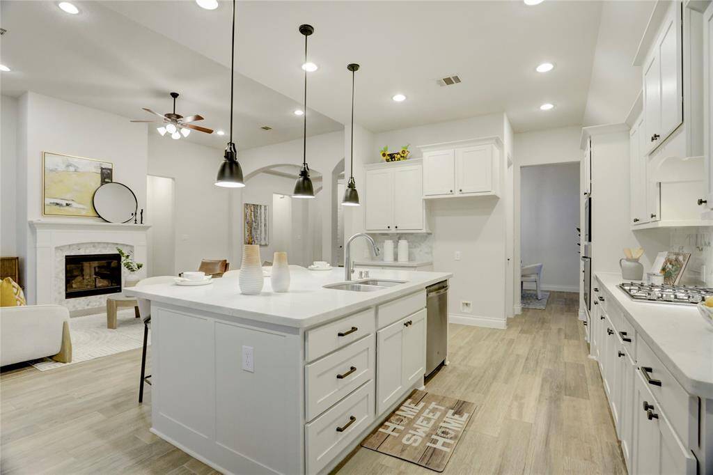 A true heart of the home, this kitchen opens beautifully to the living area, offering unobstructed views for entertaining and everyday living, anchored by a massive island and stainless appliances.