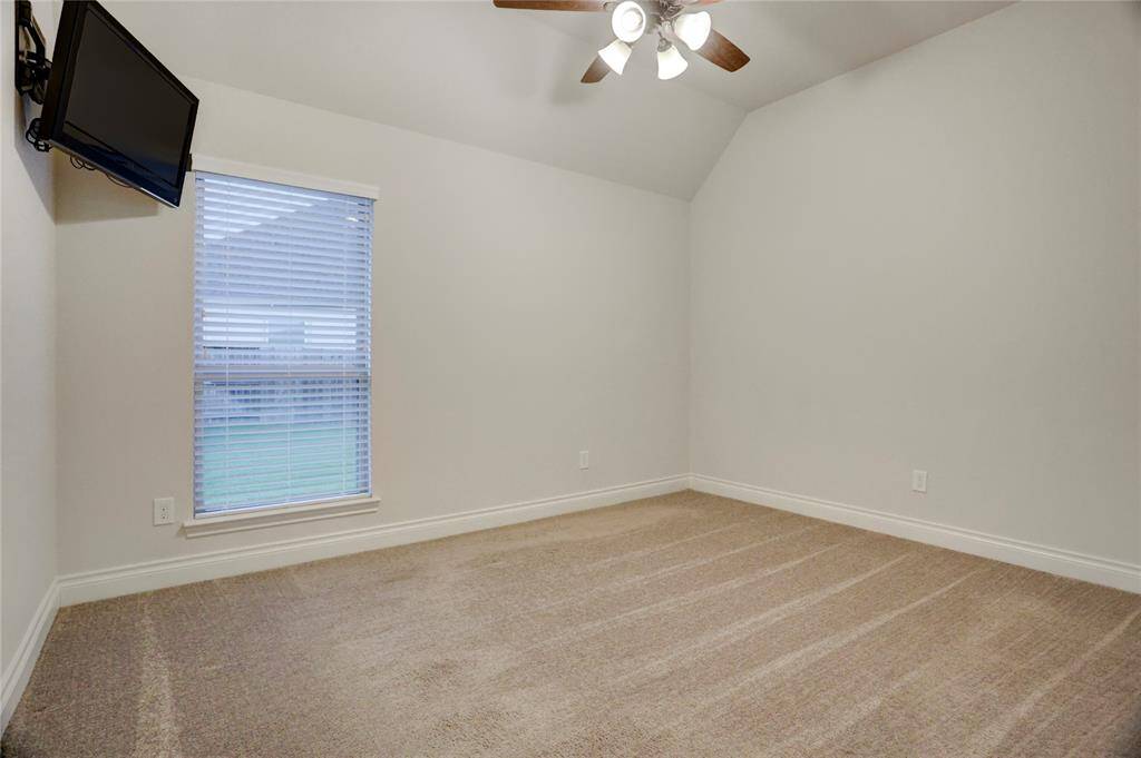 This inviting guest en-suite offers comfort and privacy, making it an ideal space for overnight visitors or extended stays. The spacious room is filled with natural light, creating a true home-away-from-home experience.