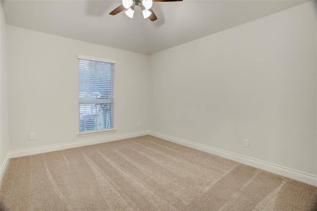 Bright and inviting, this secondary bedroom is designed for comfort with plush carpeting, a walk-in closet for added organization, and a sunlit window that brings warmth into the space. Easily accommodating a queen-sized bed, this versatile room is ready to be styled as a guest suite, bedroom, or creative space.