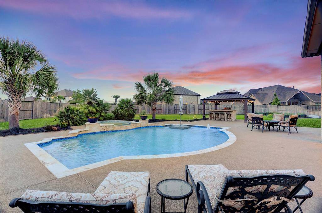 Surrounded by swaying palms and lush landscaping, this oversized backyard is the perfect canvas for summer BBQs, birthday parties, or lazy weekends in the sun. There's room for lawn games, lounging, and unforgettable memories.