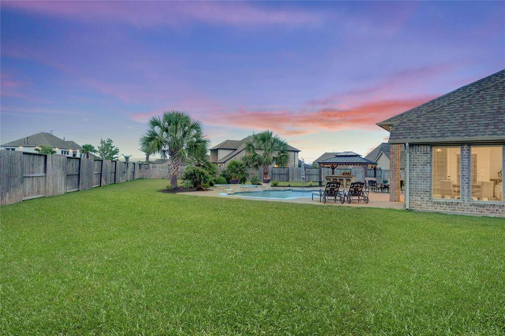 The expansive green lawn is ideal for play, pets, gardening, or adding future amenities. Whether you're chasing fireflies with the kids or laying out a blanket for stargazing, this backyard delivers space, privacy, and flexibility.