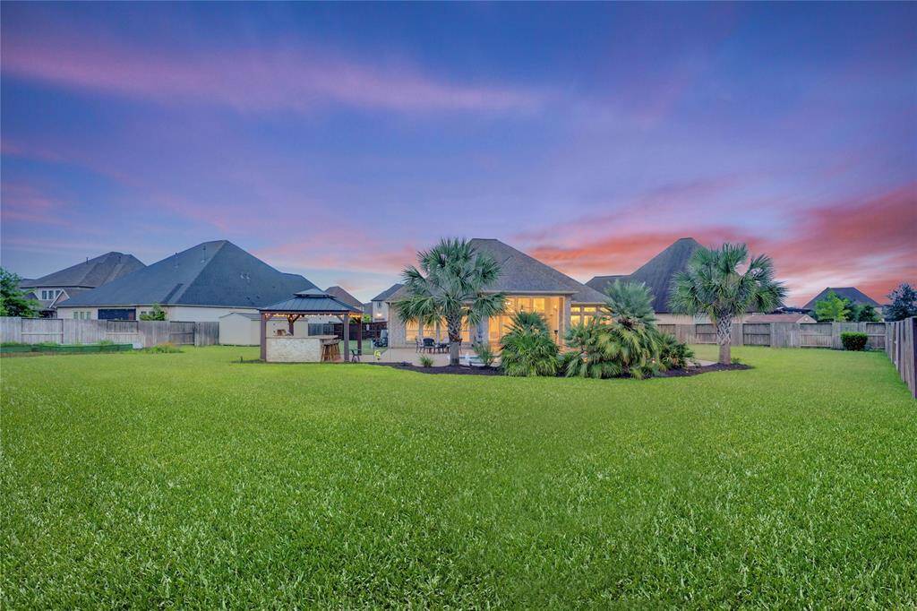 Why leave home when you have everything you need right here? With a stunning pool and spa, vibrant landscaping, dedicated grill station, and space to host the entire neighborhood, this backyard is built for making memories all year long.