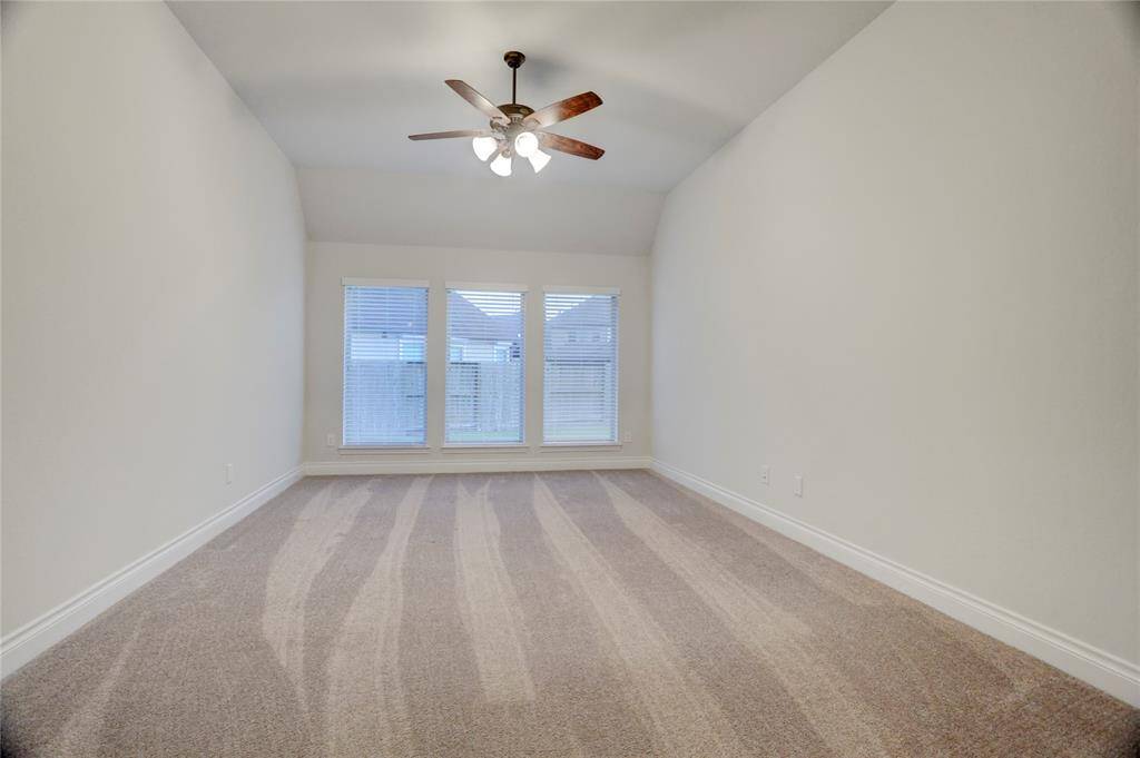 This spacious flex room offers endless possibilities to fit your lifestyle—create the ultimate game room, a dedicated playroom, a quiet second office, or even a cozy media lounge. With plush carpet, a ceiling fan, and natural light pouring through the large windows, it's a blank canvas ready to be personalized.