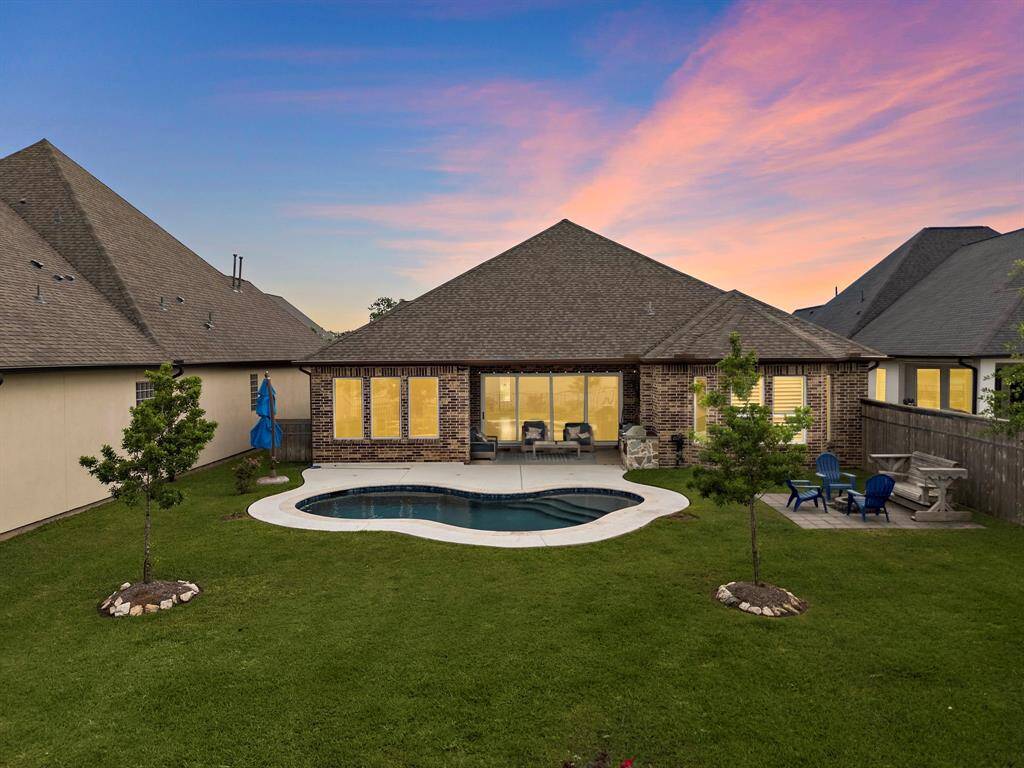 Back yard boasts an immaculately maintained yard and pool right off a pond and walking trail in the neighborhood