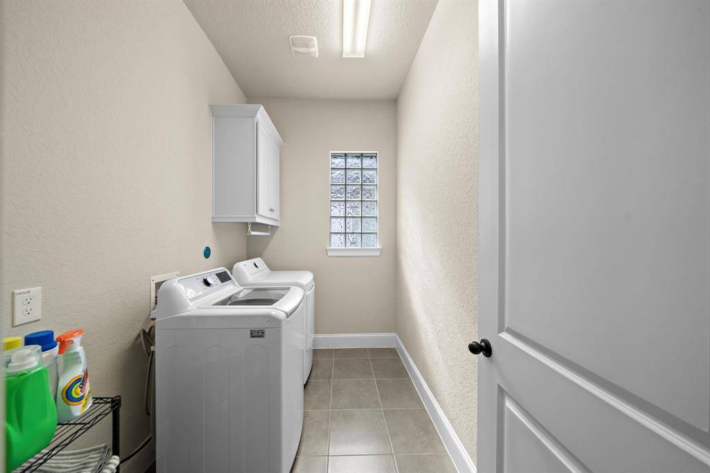 Utility room with cabinetry and ample space