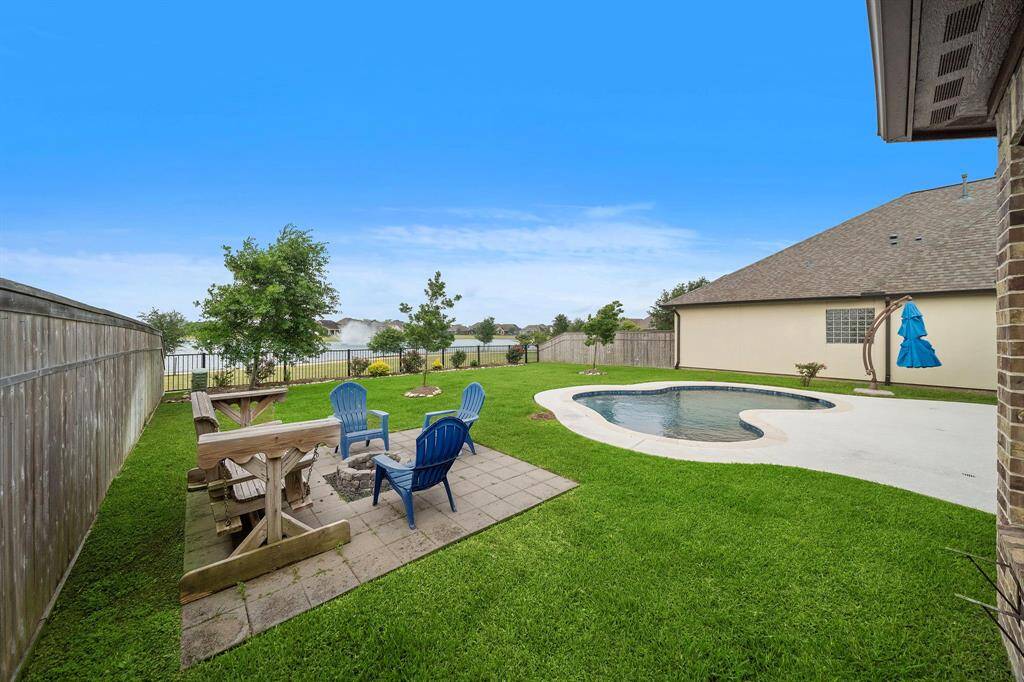 Fire pit area, swing, and chairs that will all be staying with the home