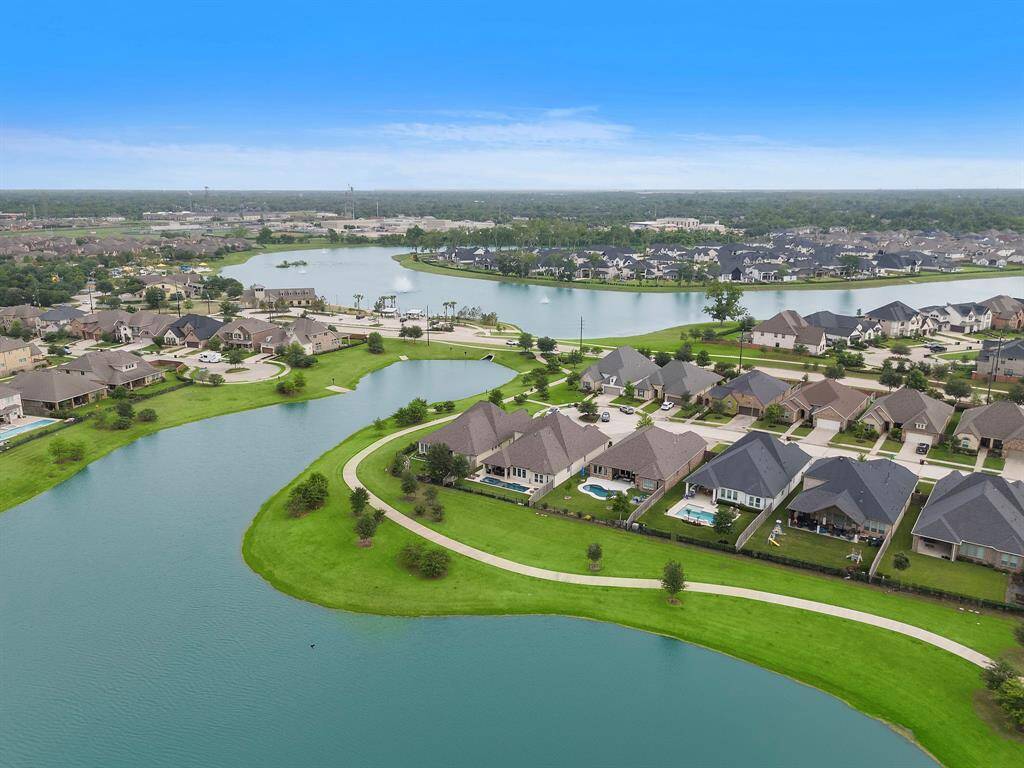 View from pond over looking the back of the home. Large pond area beyond is the amenity centers and area where all holiday fireworks can be seen