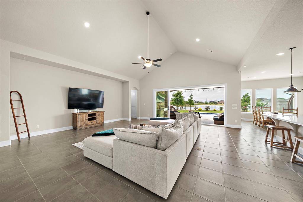 Large sliding doors open to show the beautiful indoor-outdoor living space this area offers