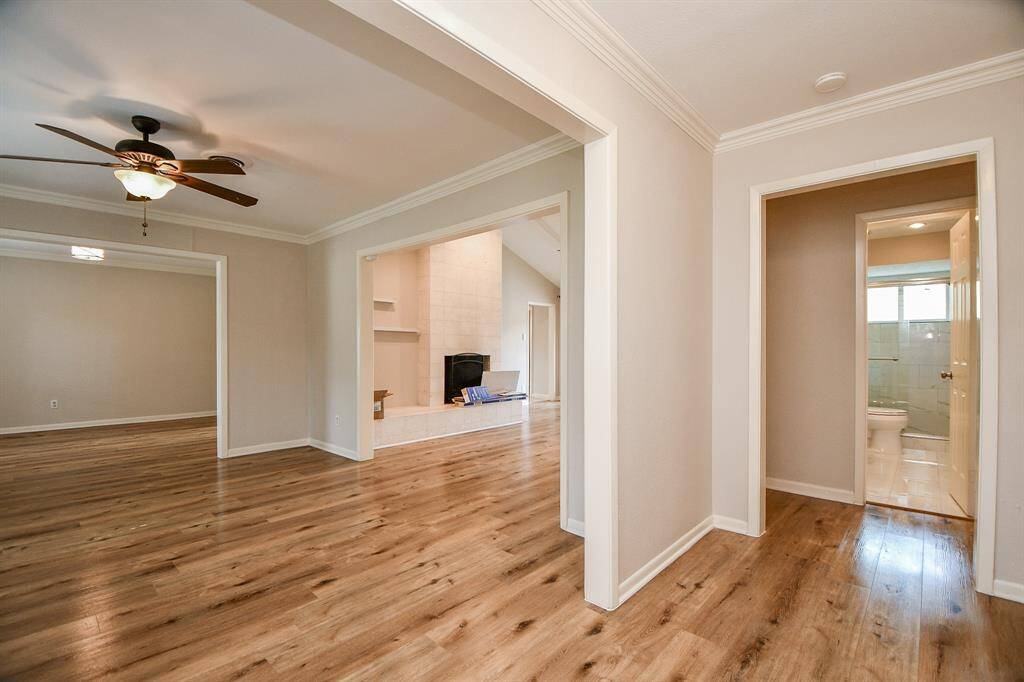 At right, is one of 2 full baths; at center, under the wide doorway, is a cozy wood burning fireplace, sure to warm spirits in any temperature!