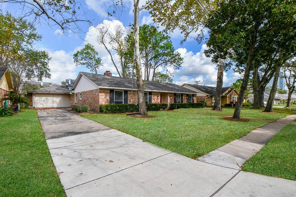 Excelllently maintained, inside and out, seen here is the home's dual detached garage, atop a long driveway to accomodate family and guest vehichles.