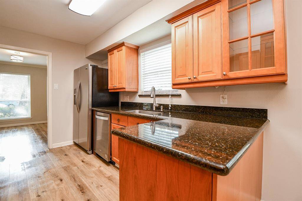 This homey chef's kitchen features deep chocolate colored granite counters, which could welcome a stool or two for quick snacks.