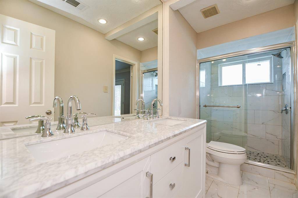 Ths large and accomodating primary bath offers complete relaxation, with a large glass enclosed shower, dual sinks set in creamy white granite counters and plenty of easy room to navigate.