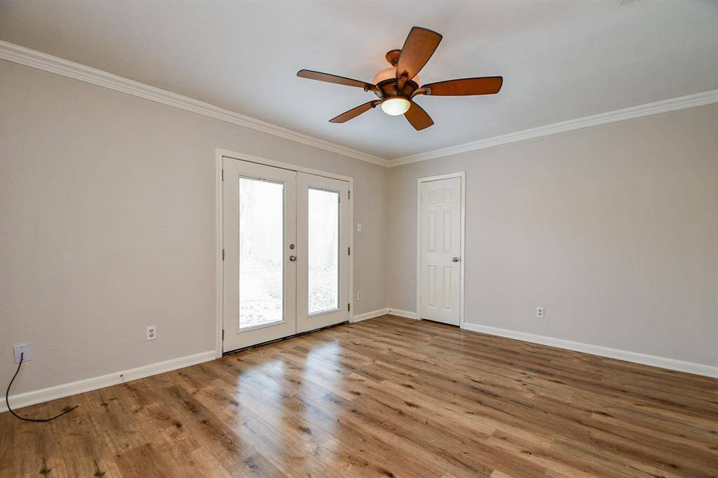 Your huge primary suite gleams with irrestible wood floors and, as seen here, has direct access to your backyard and gorgeous pool!