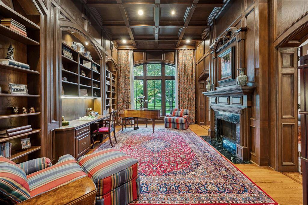 The study is an absolute masterpiece, featuring soaring 14-foot ceilings with fully paneled walls and ceiling. The double-sided gas log fireplace, adorned with antique reclaimed wood arches from New Orleans, is replicated in the study, adding a touch of historic elegance.
