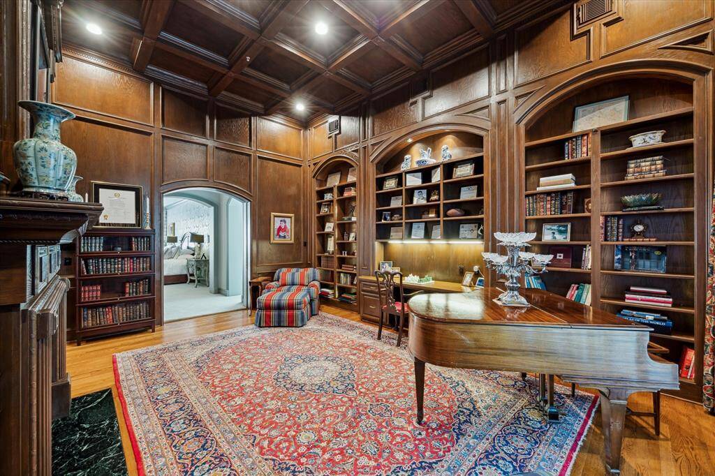 A full wall of built-ins, elegantly illuminated with rope lighting, provides the perfect space to display your most cherished items. Convenient access to the primary suite is available through pocket doors, enhancing the seamless flow and sophistication of the space.