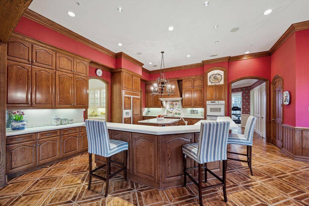 The expansive kitchen, featuring additional storage and a butler's pantry, is ideal for hosting, cooking, and entertaining.