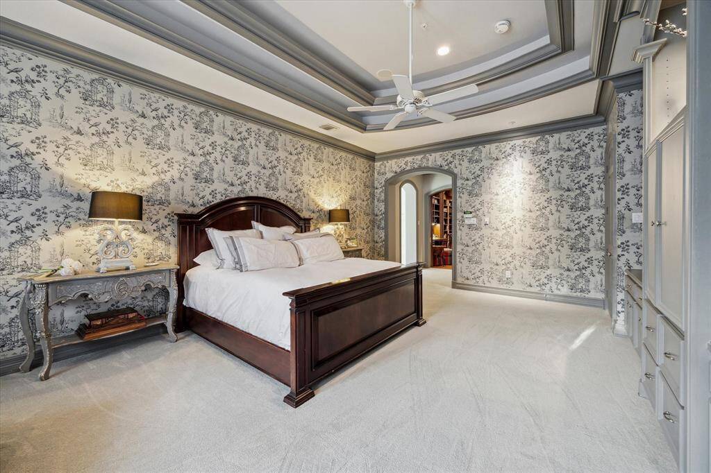 The private primary suite, elegantly accessed from the study, boasts a spacious en-suite bathroom.