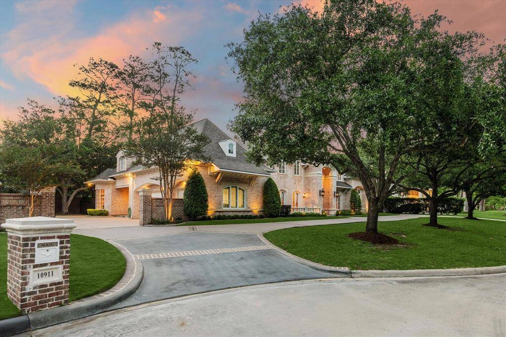 The brick lined circular driveway enhances accessibility and provides a private entrance to the three-car garage and motor court, which features an automatic iron driveway gate flanked by brick columns. Enhanced security is ensured with a brick and cast stone keyed mailbox.