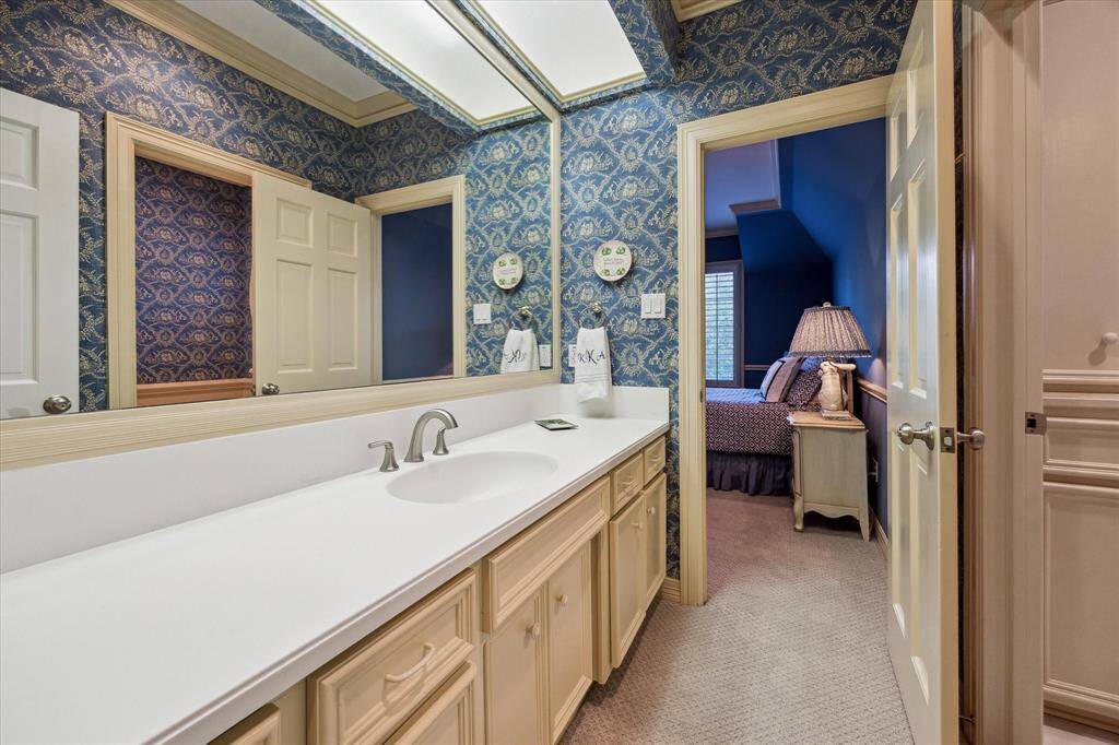 Conveniently located off the bedroom, this bathroom also offers easy access for guests in the media room.