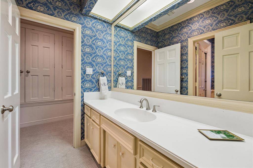 Designer wallpaper adds a touch of elegance and easy access for guests in the media room.
