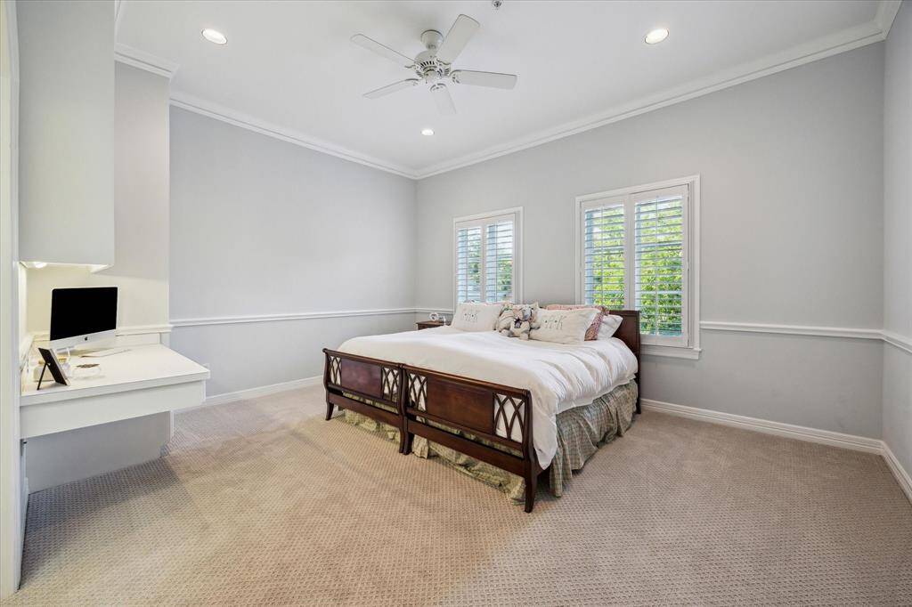 Secondary bedroom includes built in desk with en-suite full bath and large walk in closet.