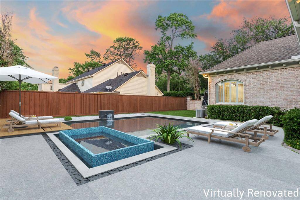*Virtually Renovated* Outdoor Yard Featuring a Spacious Pool and Expansive Patio.