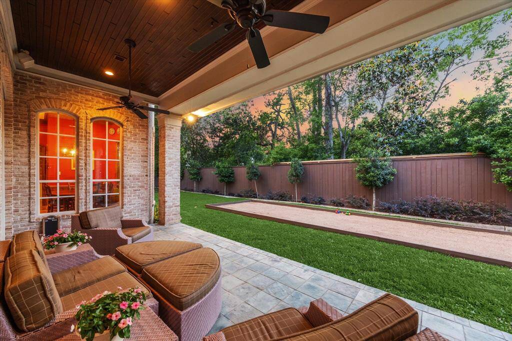 The outdoor space is charming, with a picturesque view of the bocce ball court. A mosquito control system ensures comfort on hot summer days.
