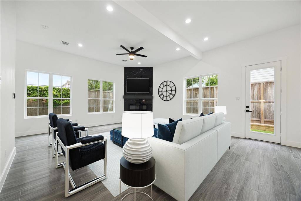 Optional view of the virtually staged living. The door leads out to the private fenced backyard