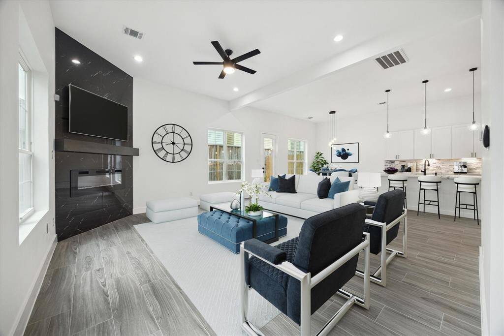 The living room has many various options for placing furniture. This one is virtually staged