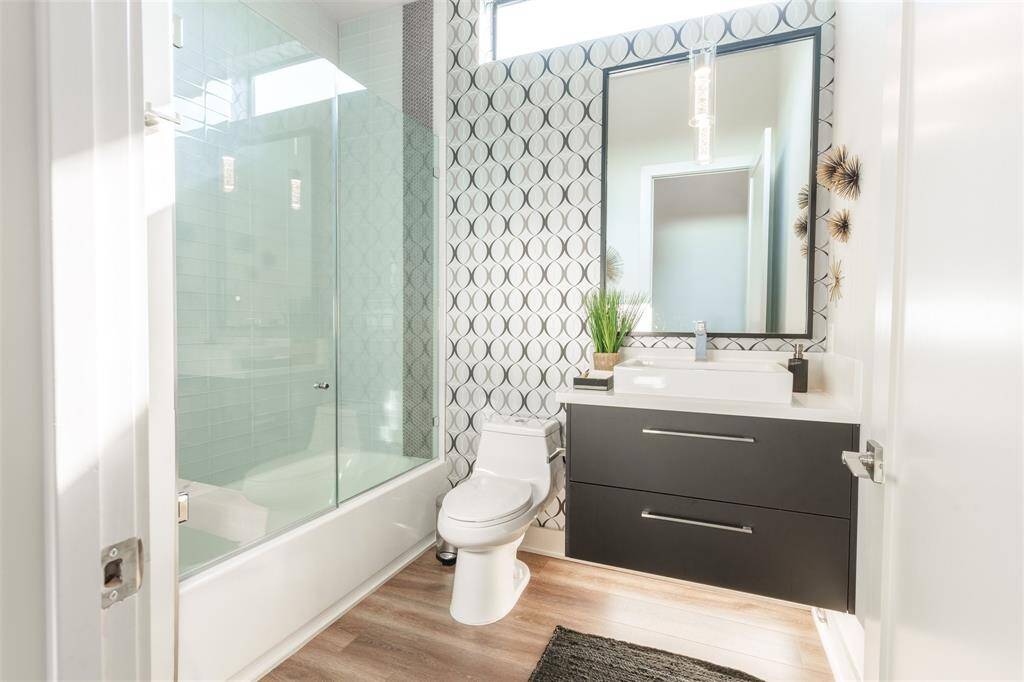 Floating Vanity with Automatic under cabinet lighting and tub to ceiling tile with glass enclosure!
