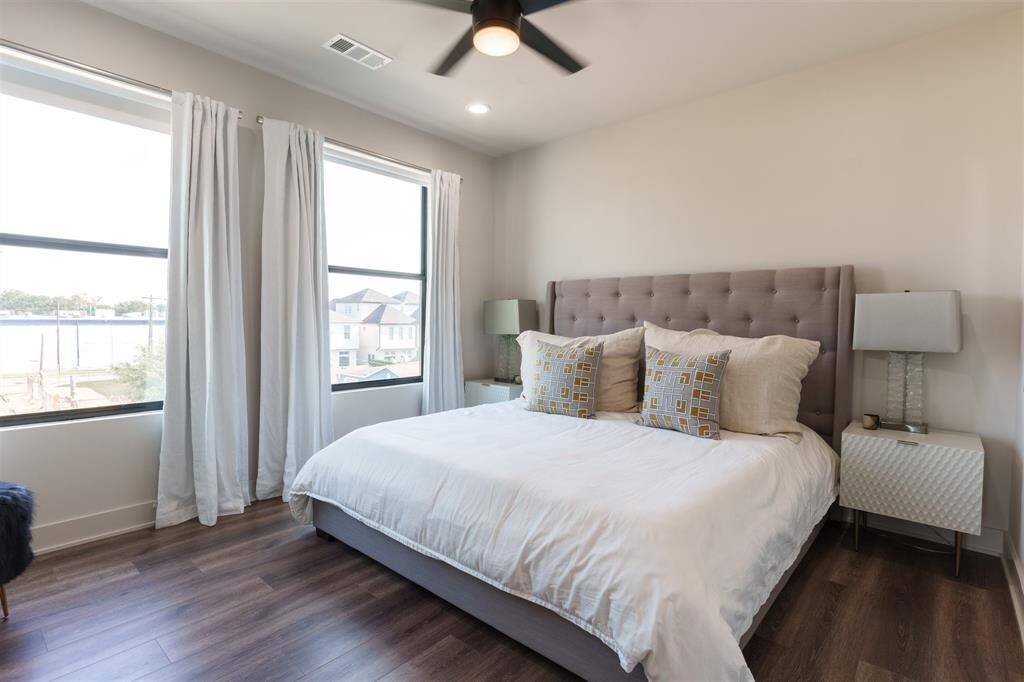 Second Bedroom on 3rd floor big enough for this king sized bed with two nightstands and featuring custom Black out window treatments