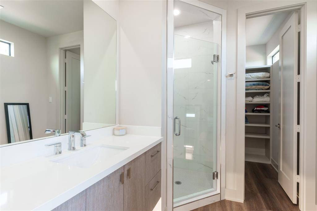 En Suite Bathroom with walk in closet. Floating Vanity with automatic under cabinet lighting and custom shower