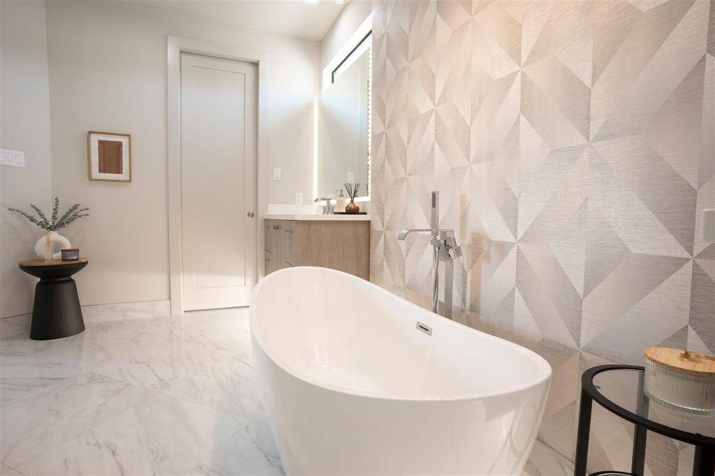 Elegant flooring with Custom Back lit Mirrors, with pocket door leading to Water Closet
