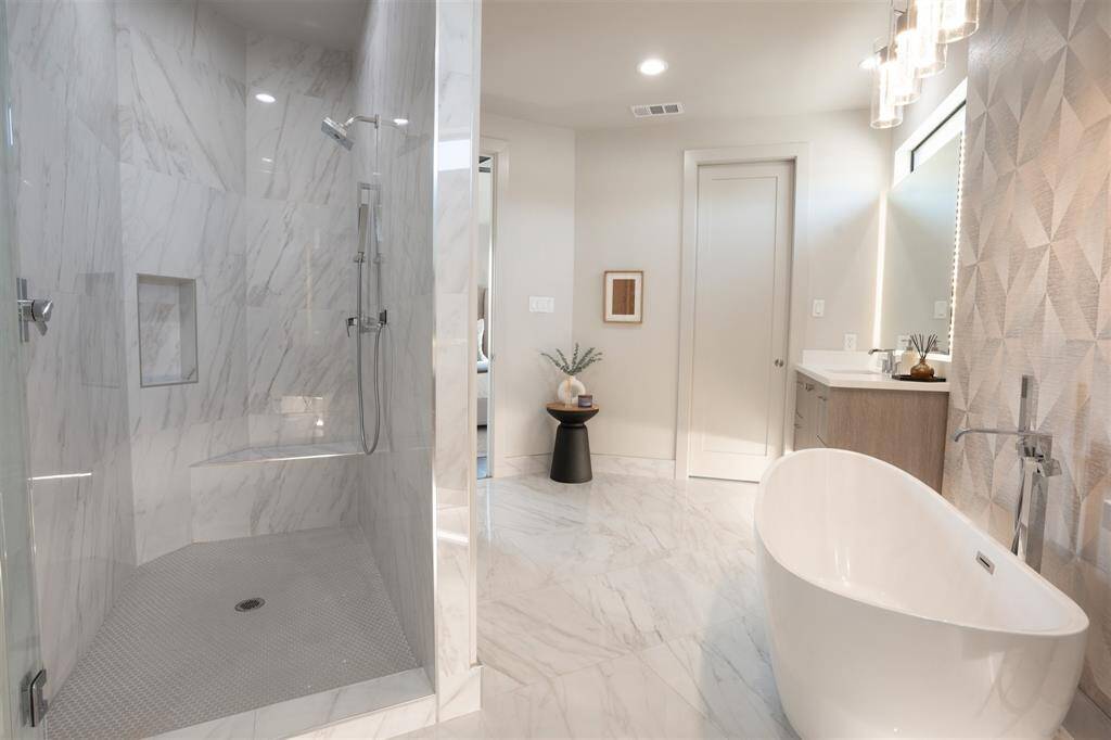 Separate Walk-In shower with bench. To complete the primary bath you have Floor to ceiling custom lien closet with pull out Landry Hamper!