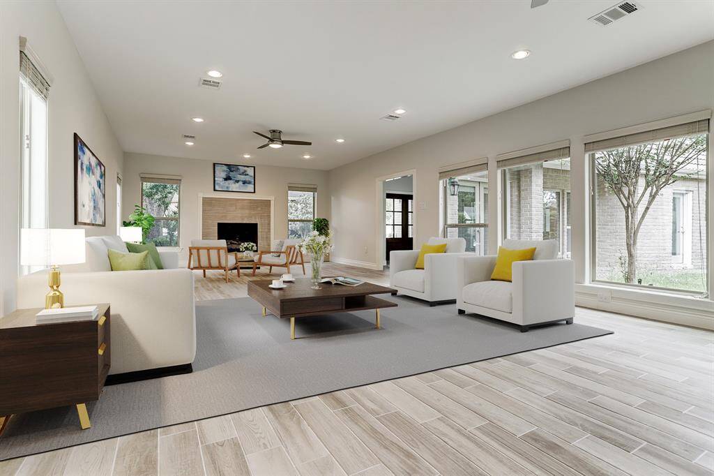 Open concept first floor living with formal and main living areas, tile flooring, large windows that fill the home with natural light and a half bath. The gas log fireplace anchors the formal living area. Virtually staged.