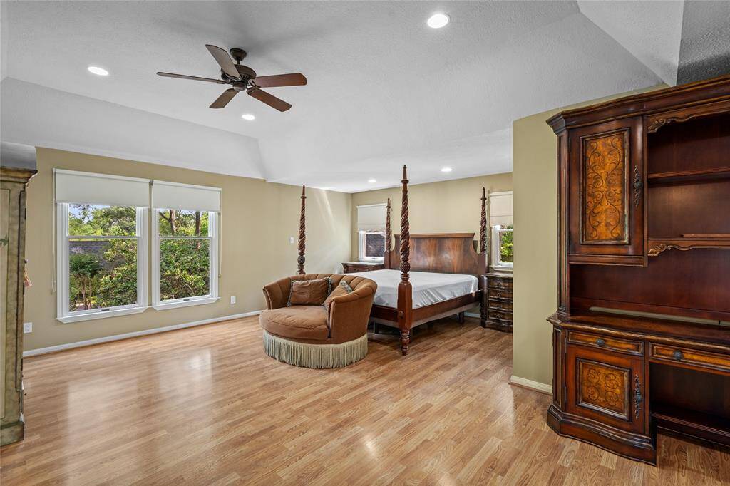 Spacious and luxurious primary suite featuring three attached walk-in closets for ultimate storage and organization. Large windows flood the room with natural light, while the beautifully updated en-suite bathroom creates a serene retreat for relaxation.